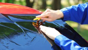 applying film to car windshield after Houston windshield repair